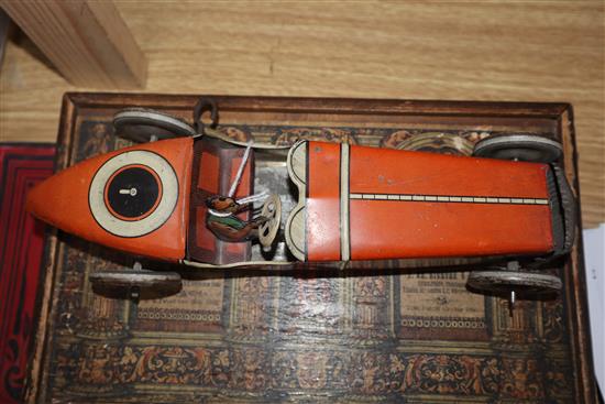 A Chad Valley tinplate racing car and a collection of other tinplate clockwork models,